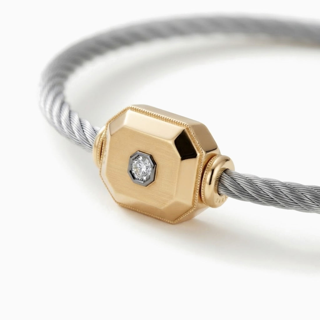 The Cornerstone men's cable bracelet with a faceted 14k gold octagon and a diamond in a black bezel