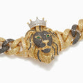 Close-up of the sculpted lion with black stone face, gold mane, white-stone crown and emerald eyes