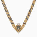 Cuban link chain with alternating black and golden stones and a crowned lion centerpiece