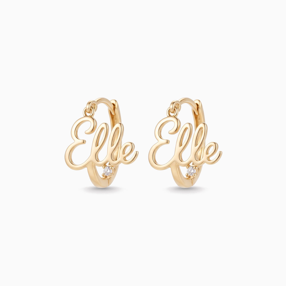 Gold hoop earrings with a script name set across the hoop