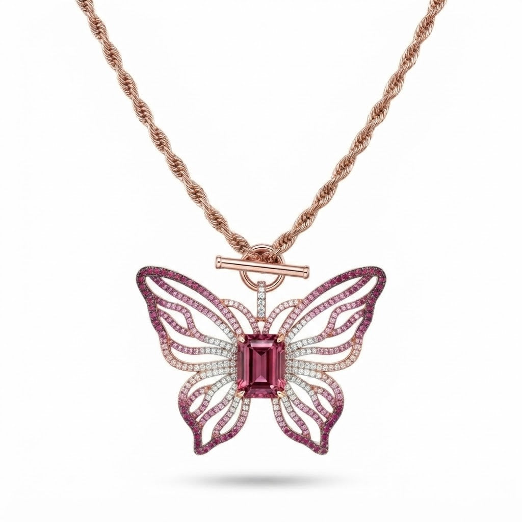 Pink open-work butterfly pendant with emerald-cut pink center stone on a rose gold rope chain with toggle clasp