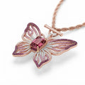 Close-up of the Papillon Rose butterfly pendant showing gradient pink pave and toggle clasp
