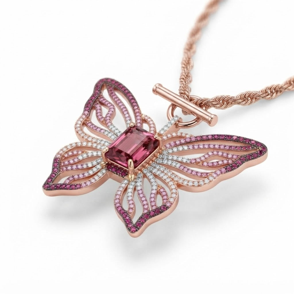 Close-up of the Papillon Rose butterfly pendant showing gradient pink pave and toggle clasp