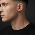 Self-Made black octagon stud earring worn on a man's ear